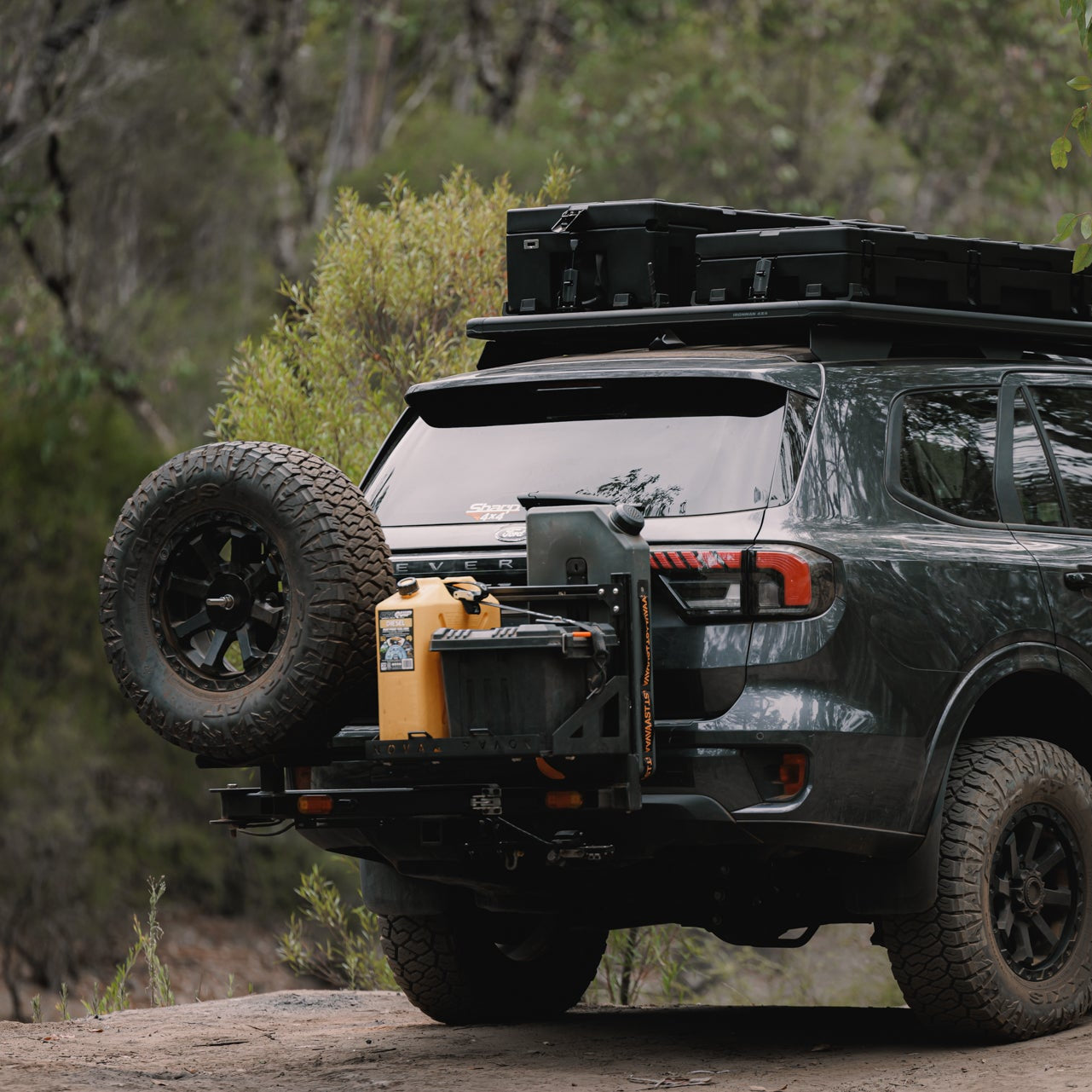 Off-road vehicle with additional tires and equipment on a forested trail