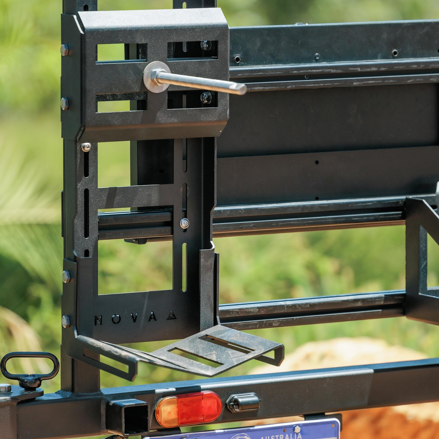 Side view of hitch-mounted swing away arm with spare tyre secured
