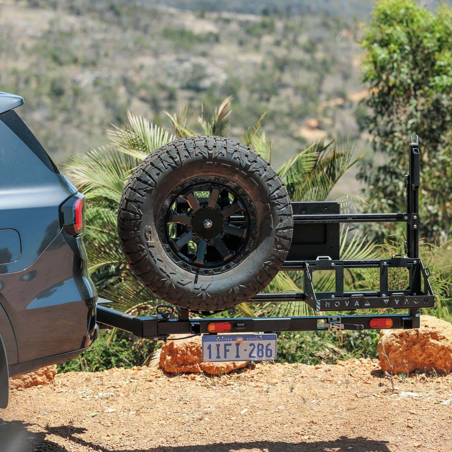 Hitch-mounted spare tyre system with tail light and plate installed