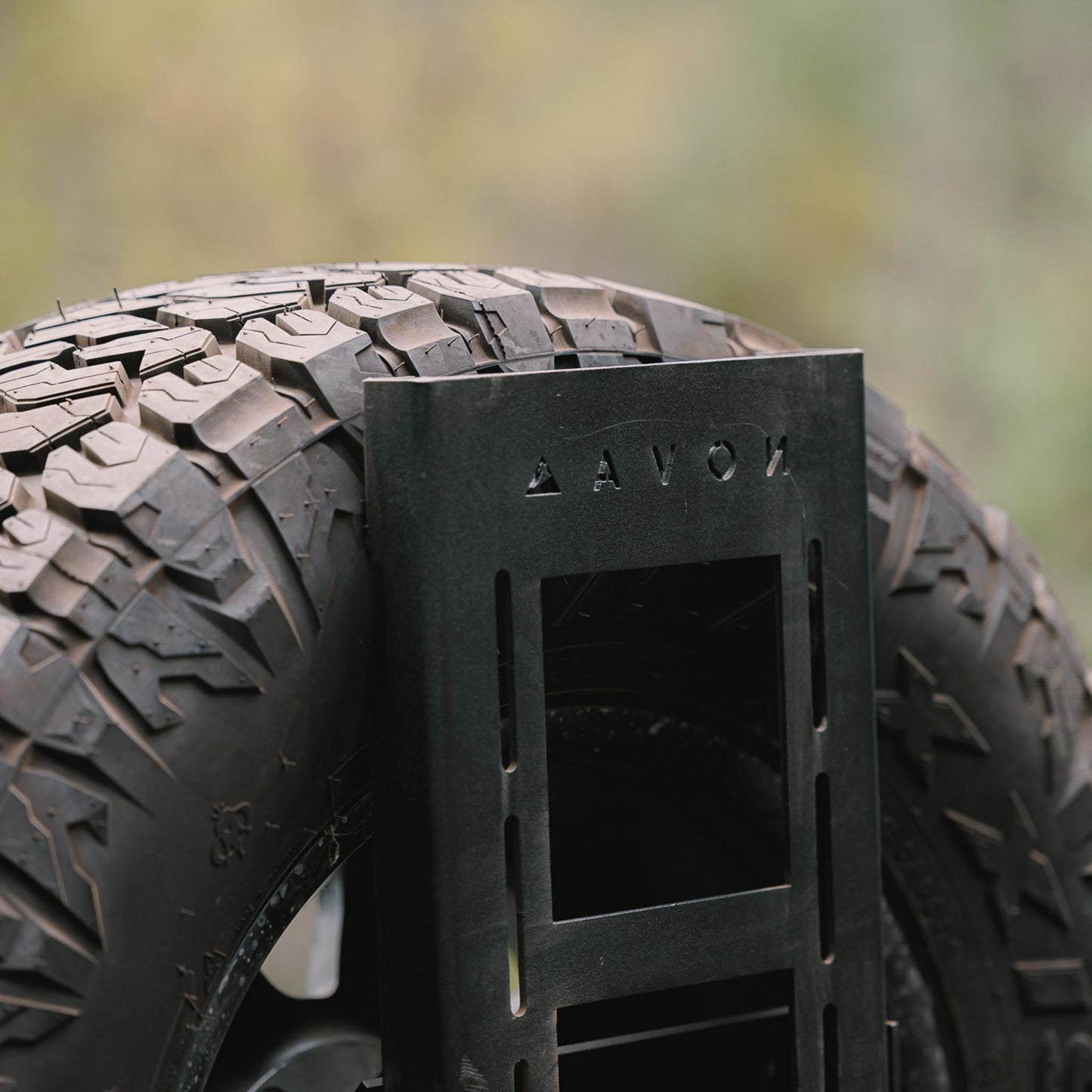 Close-up of Novaa Gear spare wheel holder mounted on swing arm system