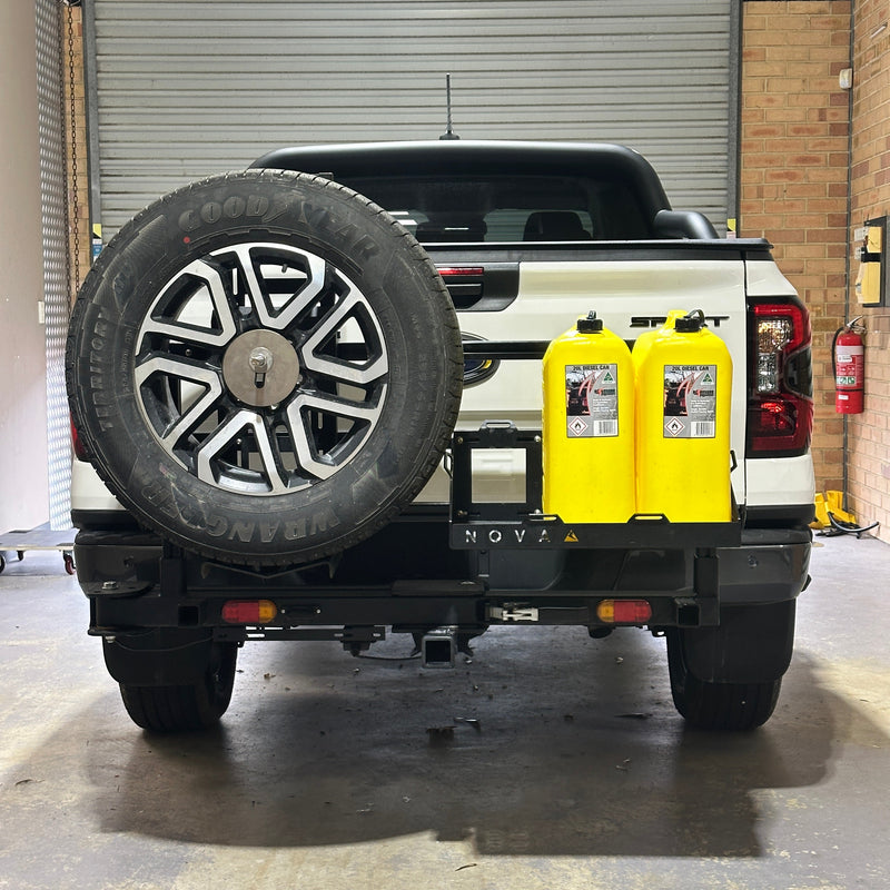 Top-down view of a black vehicle with a yellow toolbox on a concrete surface.
