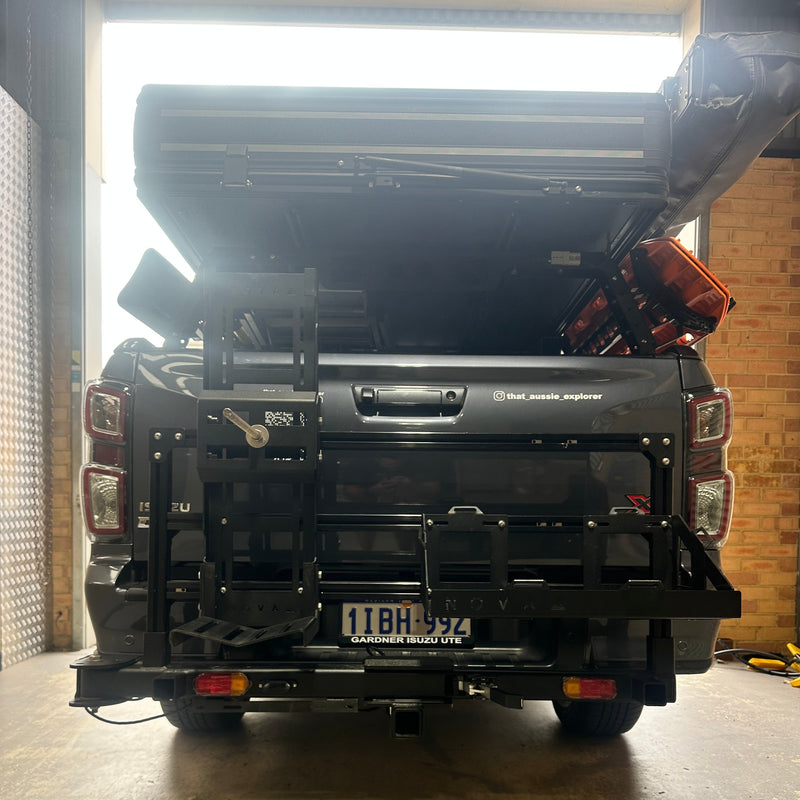 Black truck parked inside a building with sunlight streaming in