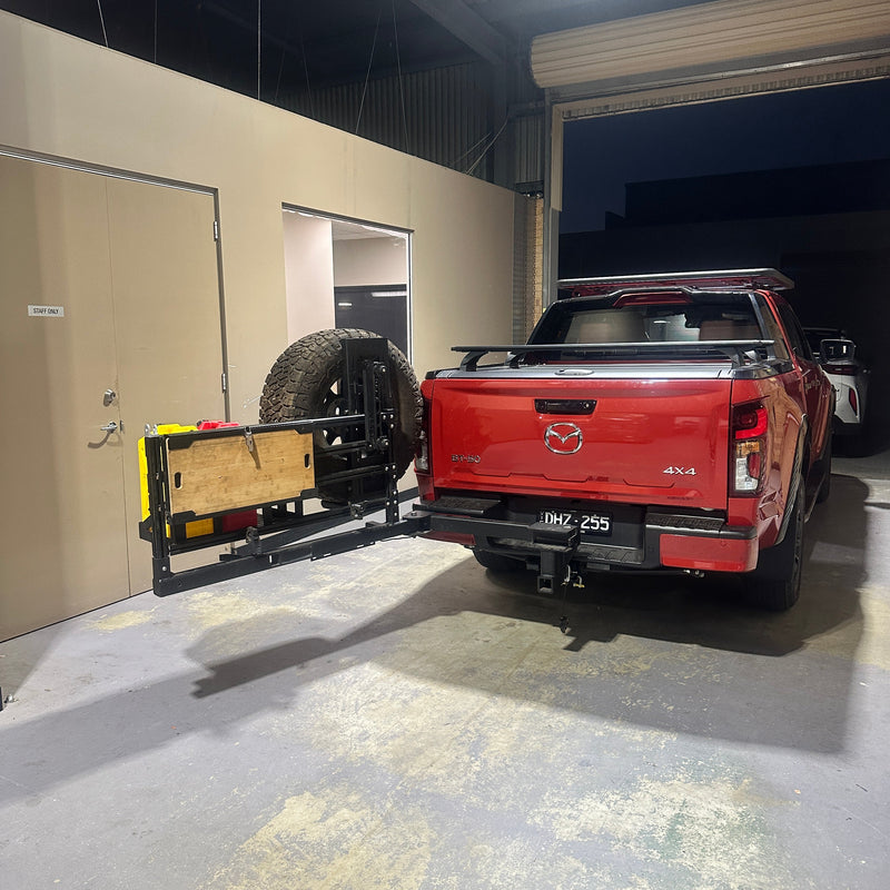 Red toy truck on a lift in a showroom setting