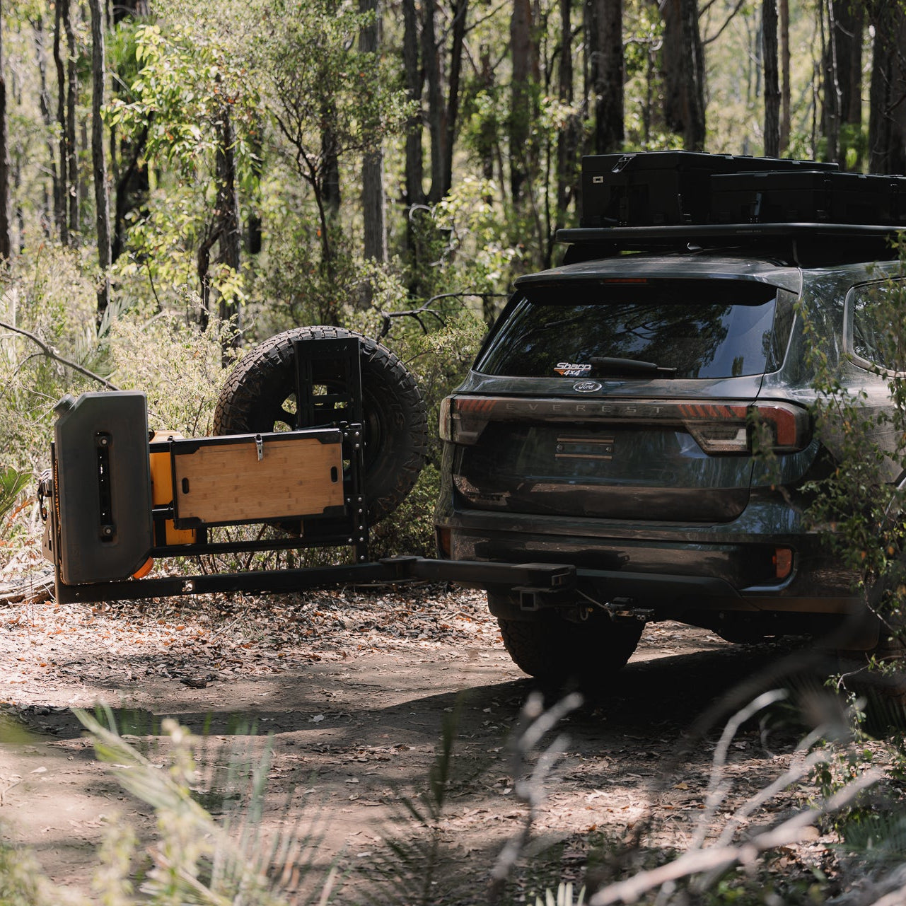 SUV with a trailer in a forest setting